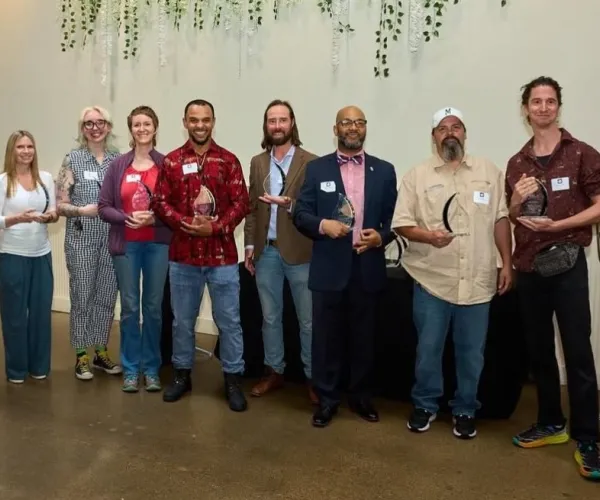 MELA grant recipients standing in line at restaurant