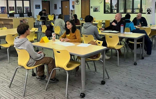 Volunteers with students at school library
