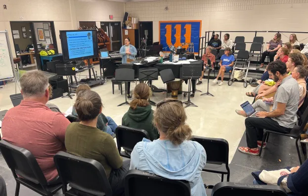Achieve coordinator making presentation to group at high school