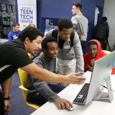 High school students and adult at computer in Best Buy Teen Tech Center