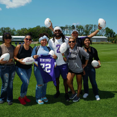 Washburn graduate Elsie with members of the Minnesota Vikings organization