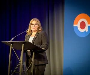 Achieve president and CEO Danielle Grant at fundraising event podium