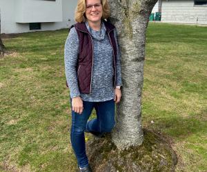 Picture of Elizabeth Bork standing by a tree