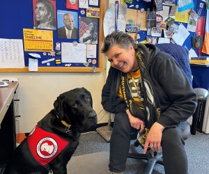 Achieve staff member with her assistance dog Lambeau