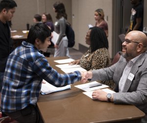 Step Up mock interview volunteer shakes the hands of a youth participant
