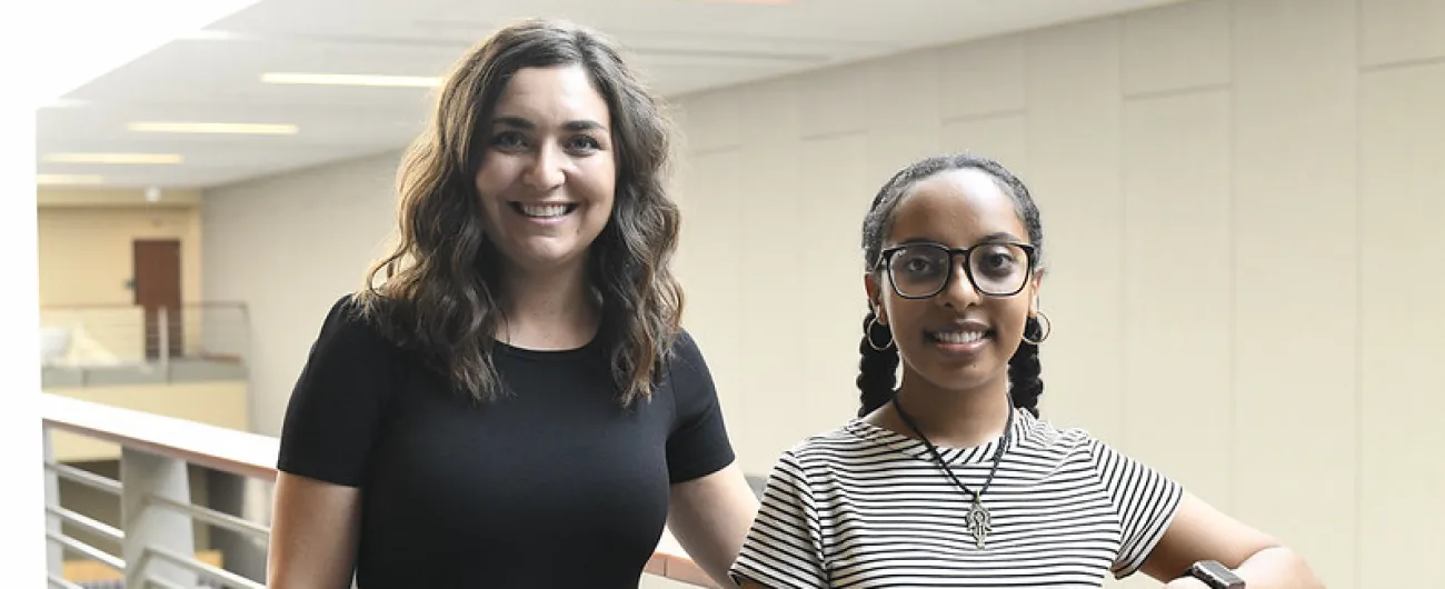 Two people standing in hall 