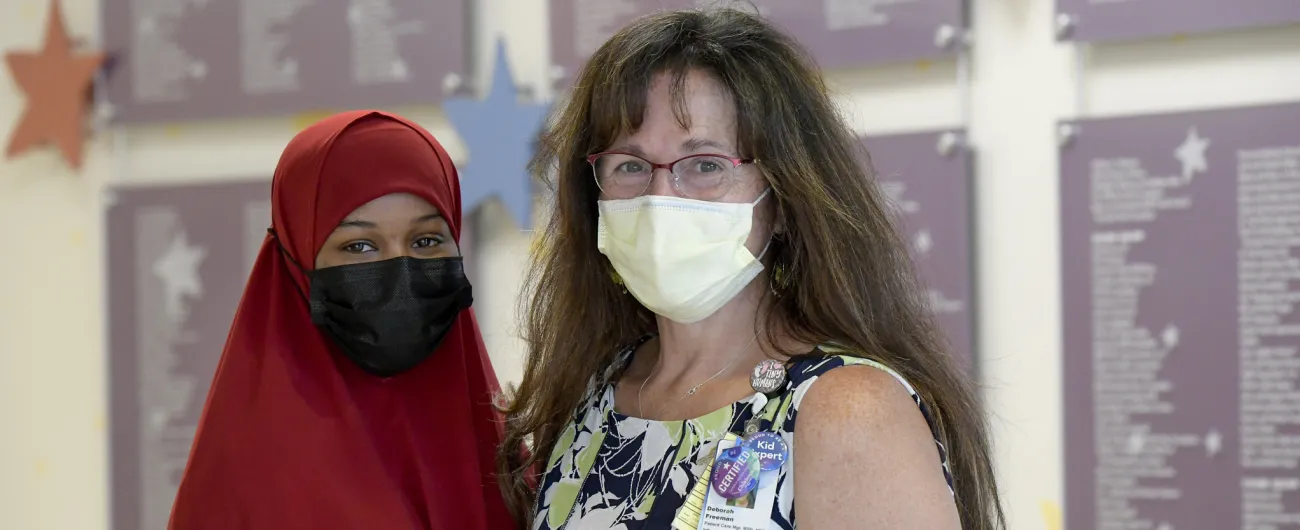 College intern and supervisor in hospital lobby 