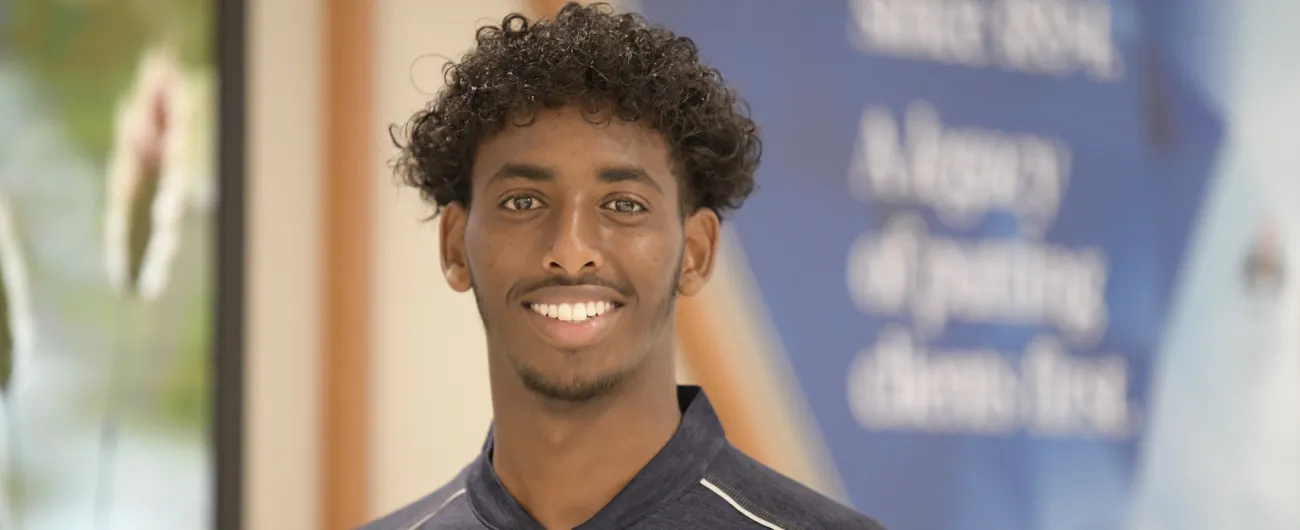 Intern in front of office wall at Amerirprise