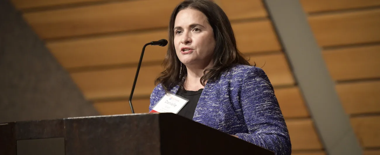 CEO Danielle Grant at podium 