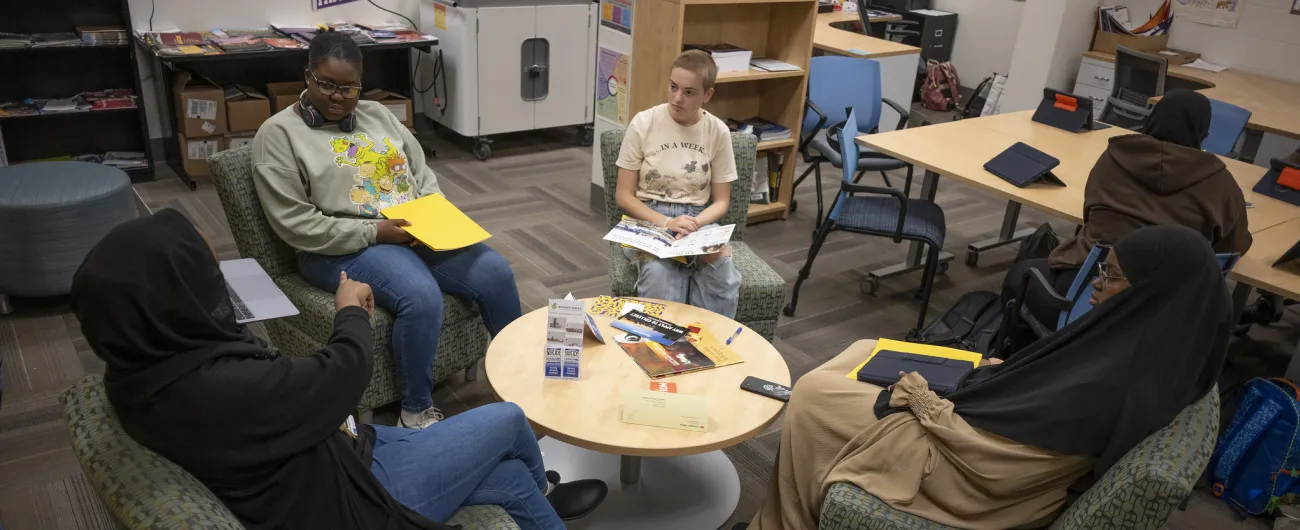 Aisha working with students on couches