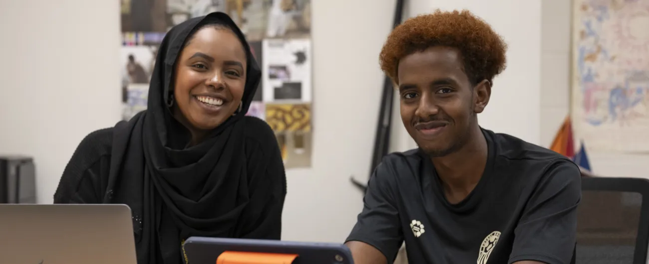 Aisha working with students at desk