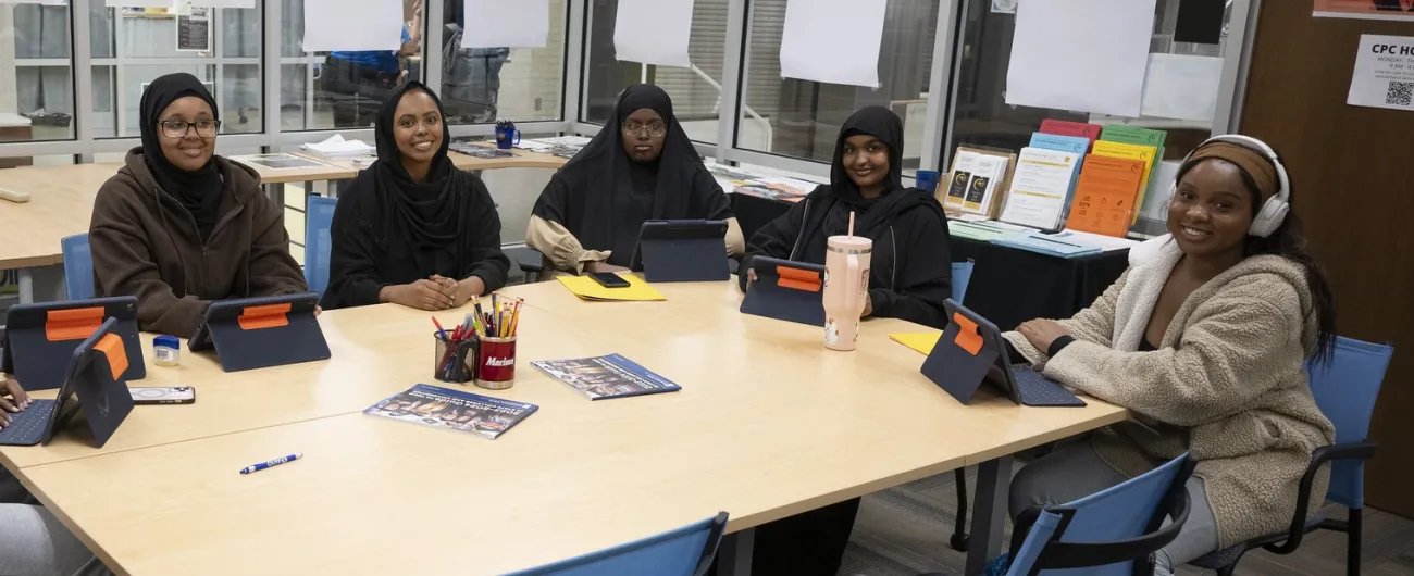 Aisha working with students at table