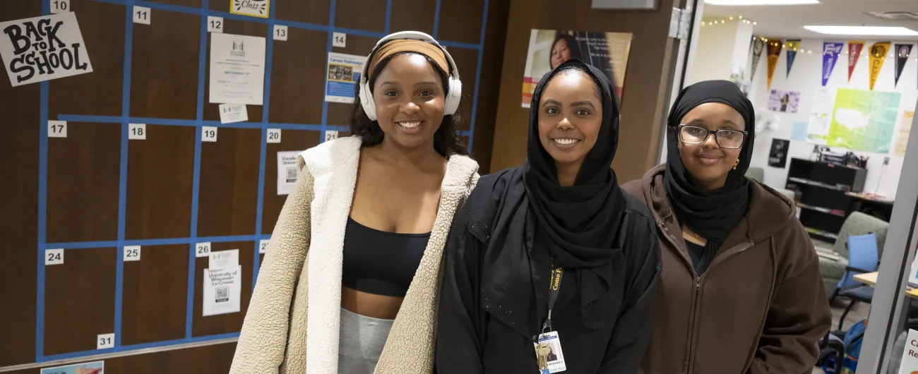 Aisha working with students in front of the CRC door