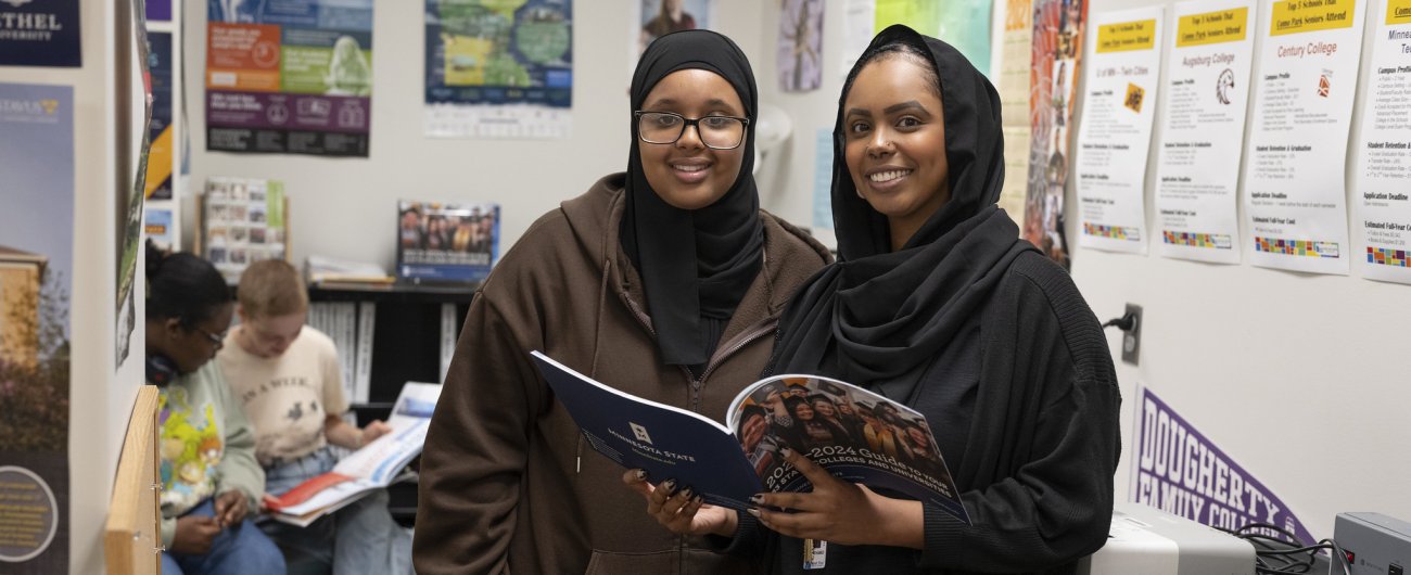 Aisha working with student, standing together