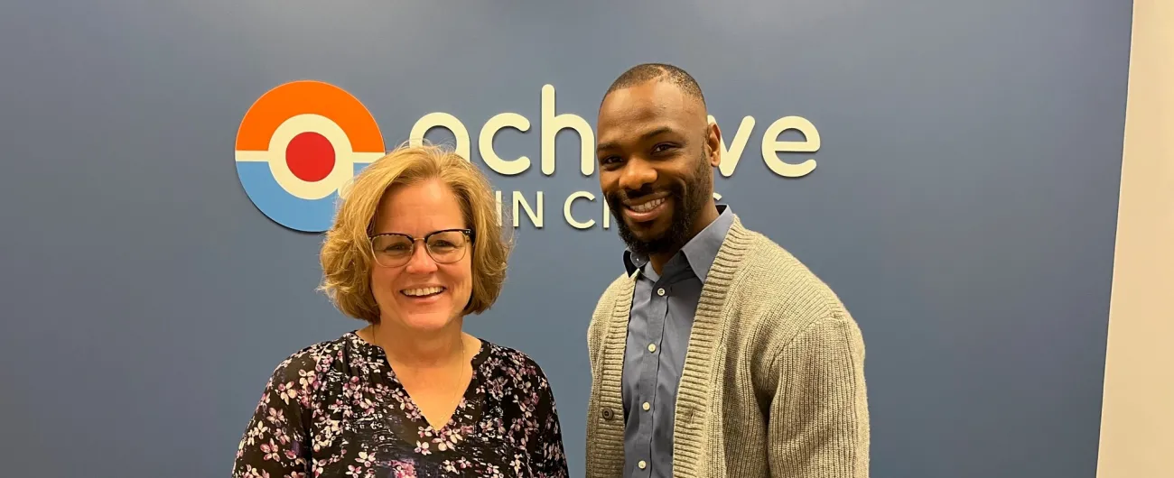 Achieve Twin Cities new office with staff in front of Achieve logo